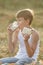 Teenage farmer boy enjoying fresh milk and bread