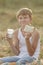 Teenage farmer boy holding milk and bread