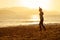 Teenage girl balance slackline silhouette on the beach