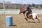 Teenage girl barrel racing