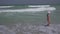 Teenage girl in a bathing suit happily jumps in the waves of Persian Gulf on beach of Dubai stock footage video
