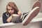 Teenage girl in black sneakers sits in bath, closeup