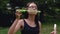 Teenage girl blowing soap bubbles in summer