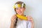 A teenage girl with a bouquet on her head eats corn