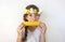 A teenage girl with a bouquet on her head eats corn