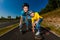 Teenage girl and boy rollerblading against blue sky