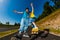 Teenage girl and boy rollerblading against blue sky