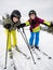 Teenage girl and boy skiing