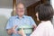 Teenage Girl Bringing Meal For Elderly Male Neighbour