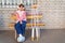 a teenage girl with a broken leg and crutches sits on a bench