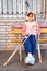 a teenage girl with a broken leg and crutches sits on a bench