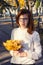 Teenage girl with bundle of maple leaves