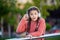Teenage girl cant hear because of music playing in headphones. Teenager taking off headphones