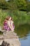 Teenage Girl With Closed Eyes Sitting On Rock