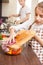 Teenage girl cooking together with her family