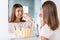 teenage girl curling her lashes at bathroom