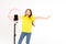 A teenage girl dances and shoots a video. Selfies. The phone is mounted on a tripod and the ring lamp shines. Emotion of delight