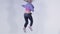 Teenage girl dancing hip-hop in colorful clothes, studio. Hip-hop dancer girl posing making acrobatic moves