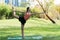 Teenage girl doing Yoga in the parks. Young girl setting on Yoga mat on the grass in the park exercises outdoors.