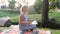 a teenage girl draws sitting on the nature near the river.