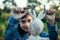 A teenage girl dries a toy hare on a clothesline.