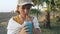 A teenage girl drinks a blue soft drink from a transparent glass.