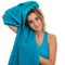 Teenage girl drying her wet hair with a towel