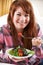 Teenage Girl Eating Plate Of Healthy Salad