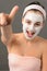 Teenage girl facial mask beauty shouting thumb-up