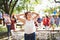 A teenage girl on a family celebration or a garden party outside.