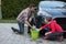 Teenage girl and father washing a car