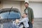 Teenage girl and father washing a car on a sunny day