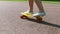 Teenage girl feet riding short modern skateboard