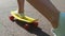 Teenage girl feet riding short modern skateboard