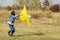 Teenage girl flying a yellow kite. Beautiful young girl kite fly. Happy little girl running with kite in hands on the beautiful