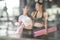 A teenage girl friend is walking holding a purple yoga mats after giving up yoga on the gym blurry foreground, A photo through a