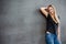 Teenage girl in front of concrete wall