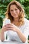 Teenage Girl In Garden Sending Text Message