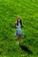 Teenage girl gathering flowers in green fields