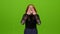 Teenage girl gets angry and screams, she is excited. Green screen
