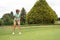 Teenage girl golfing