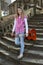 Teenage Girl With Guitar Walking Down the Old Stone Stairs in the Park