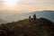 Teenage girl and a guy are walking along a stony ridge