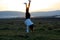 Teenage girl Handstanding on a field in late winter afternoon