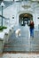 A teenage girl and her dog running down the stairs at Indiana University.