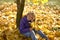 A teenage girl with her hair down walks in the forest Park in the autumn.