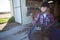 Teenage girl holding horse equipments in the stable