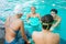 teenage girl holding a plastic float board while chatting and swimming together