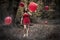 Teenage Girl Holding Red Balloon In Misty Forest With Floating B