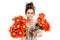 Teenage girl holding two bunches of fake flowers.